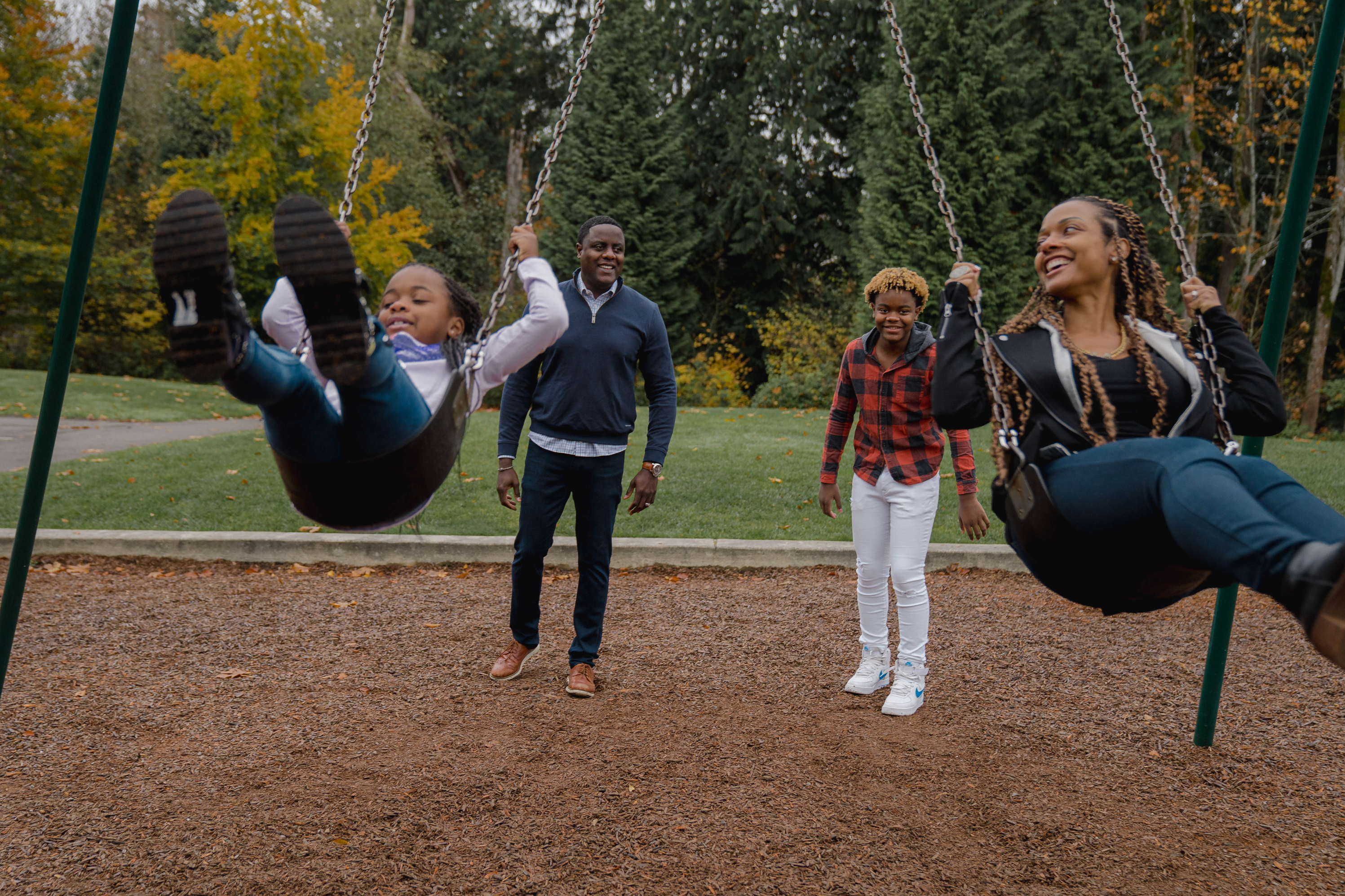 Will Station, a vice president at Boeing (second from left) plays with his children, Taylor (left) and Jaden, and his wife April, near their home in Newcastle, Wash. During the pandemic, Station has not traveled for work, so he's spent a lot more time at home with his family. (Jovelle Tamayo for NPR)
