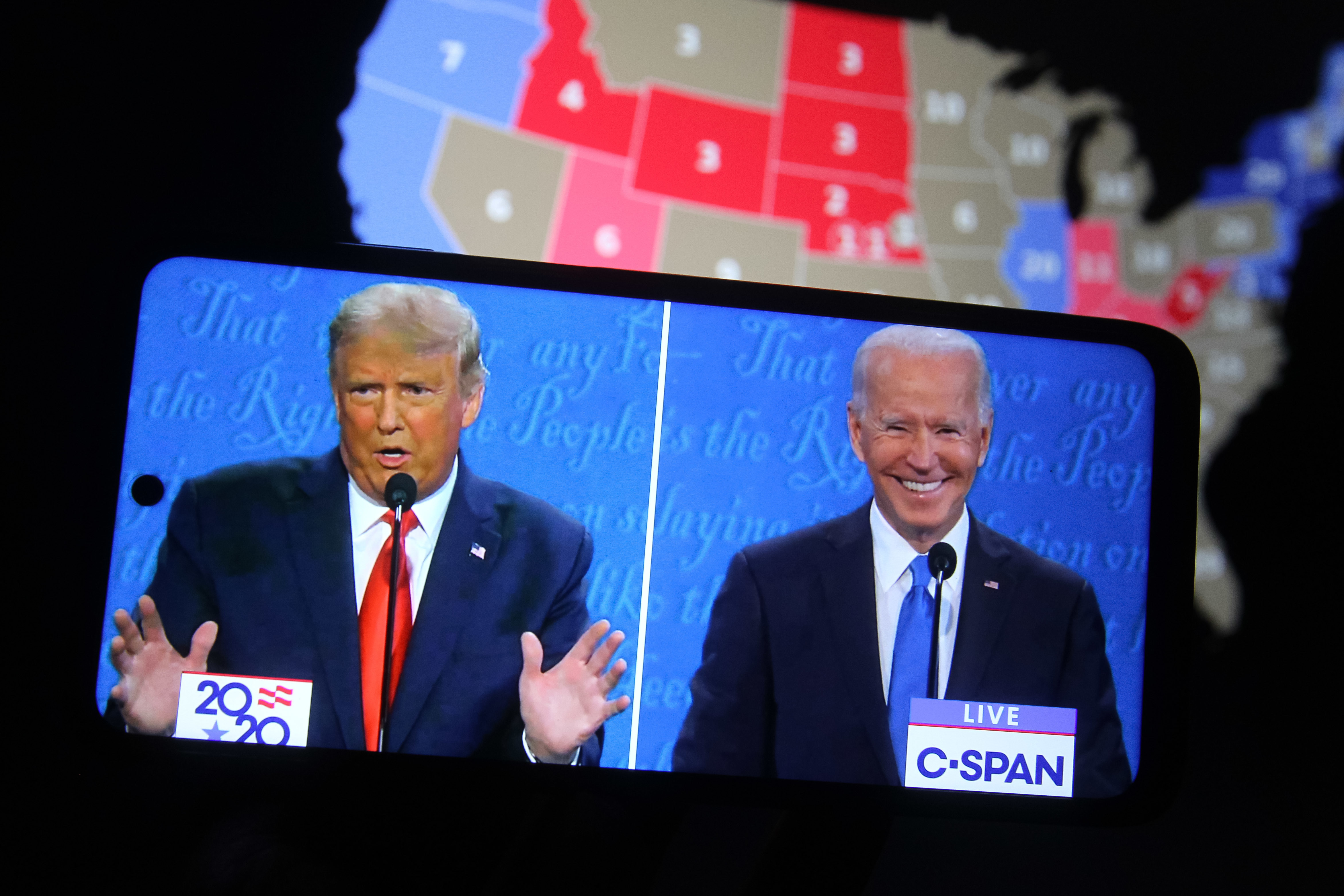 Some major final steps for the 2020 census are set to take place during the transition from President Trump to President-elect Joe Biden, who both appear above on a smartphone displaying the final presidential debate in October. (SOPA Images/LightRocket via Getty Images)
