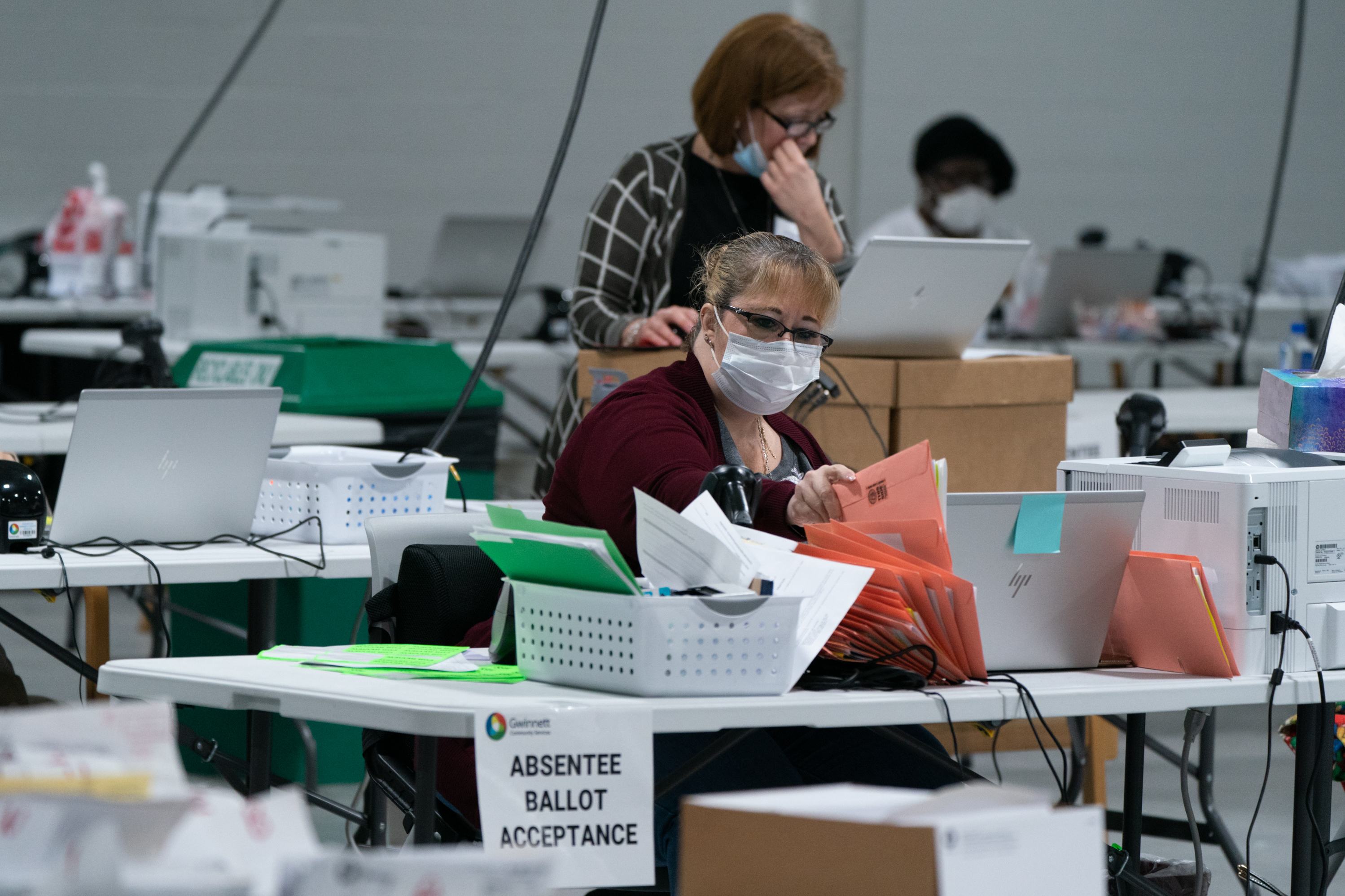 Election personnel sort ballots in preparation for an audit at the Gwinnett County Board of Voter Registrations and Elections offices on Saturday in Lawrenceville, Ga. President Trump's attempt at legal action to contest the results of the election have so far been mostly unsuccessful. (Getty Images)