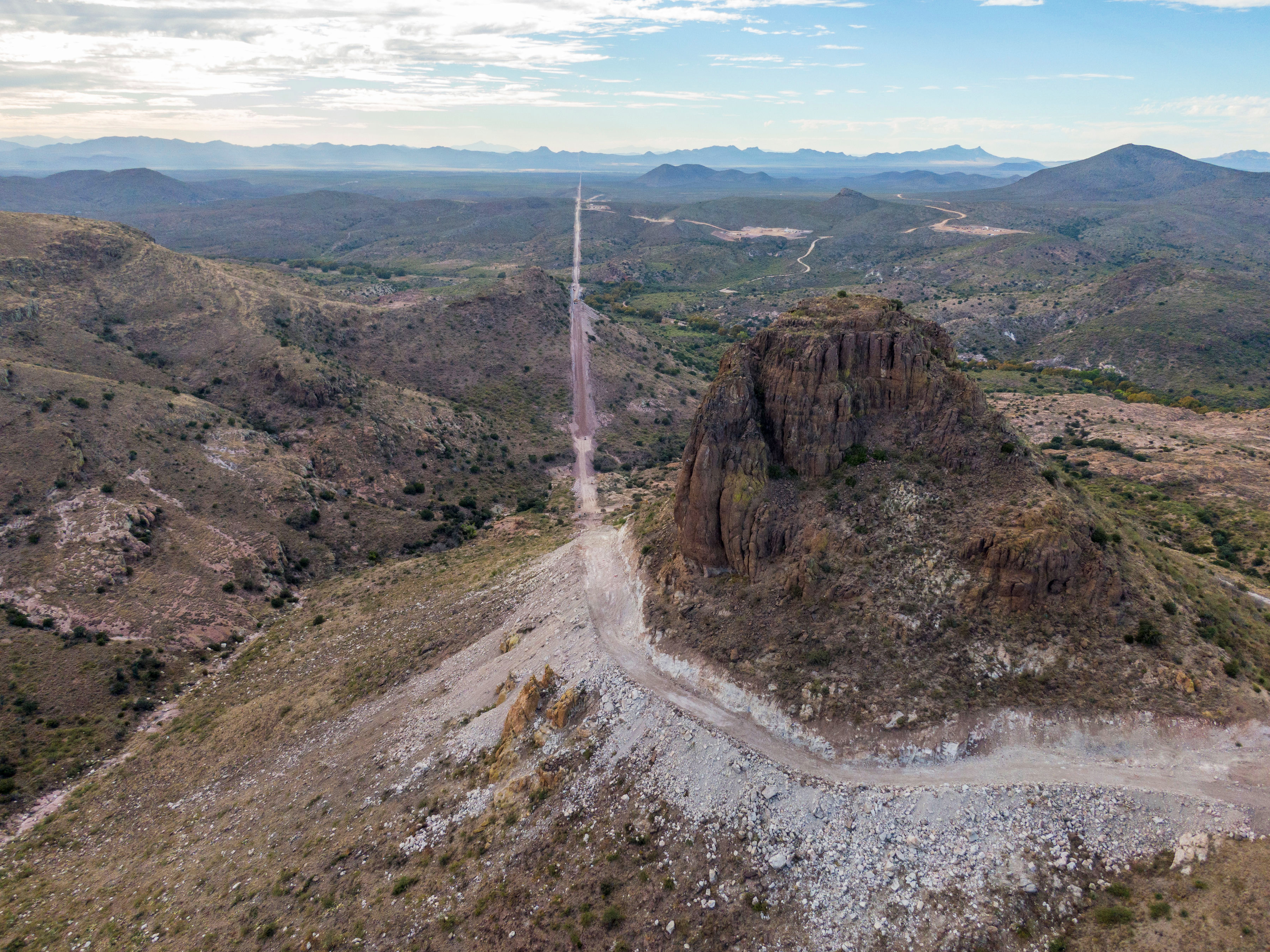 In the Guadalupe Canyon in southeastern Arizona, work crews are dynamiting mountainsides and bulldozing access roads in this stunning landscape to make way for the border wall. Mexico is on the left. (John Kurc)