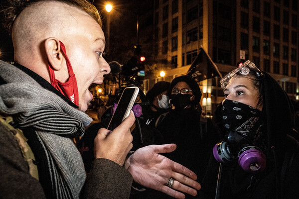 A counterprotester has a debate with a Trump supporter. She asks him to leave as he walks through the crowd of counterprotesters.