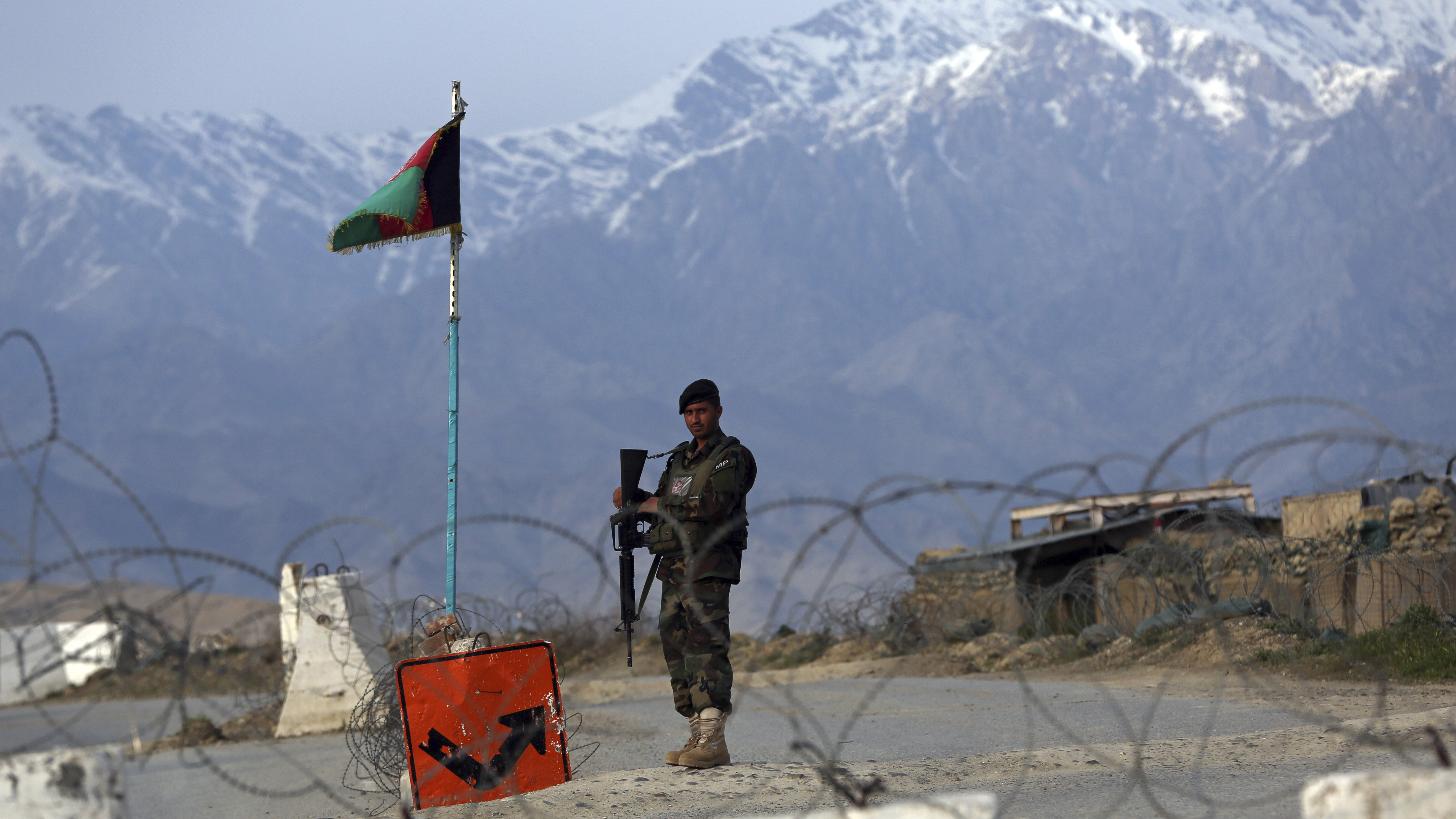An Afghan National Army soldier stands guard at a checkpoint near the Bagram airfield, the largest U.S. military base in Afghanistan, in April.