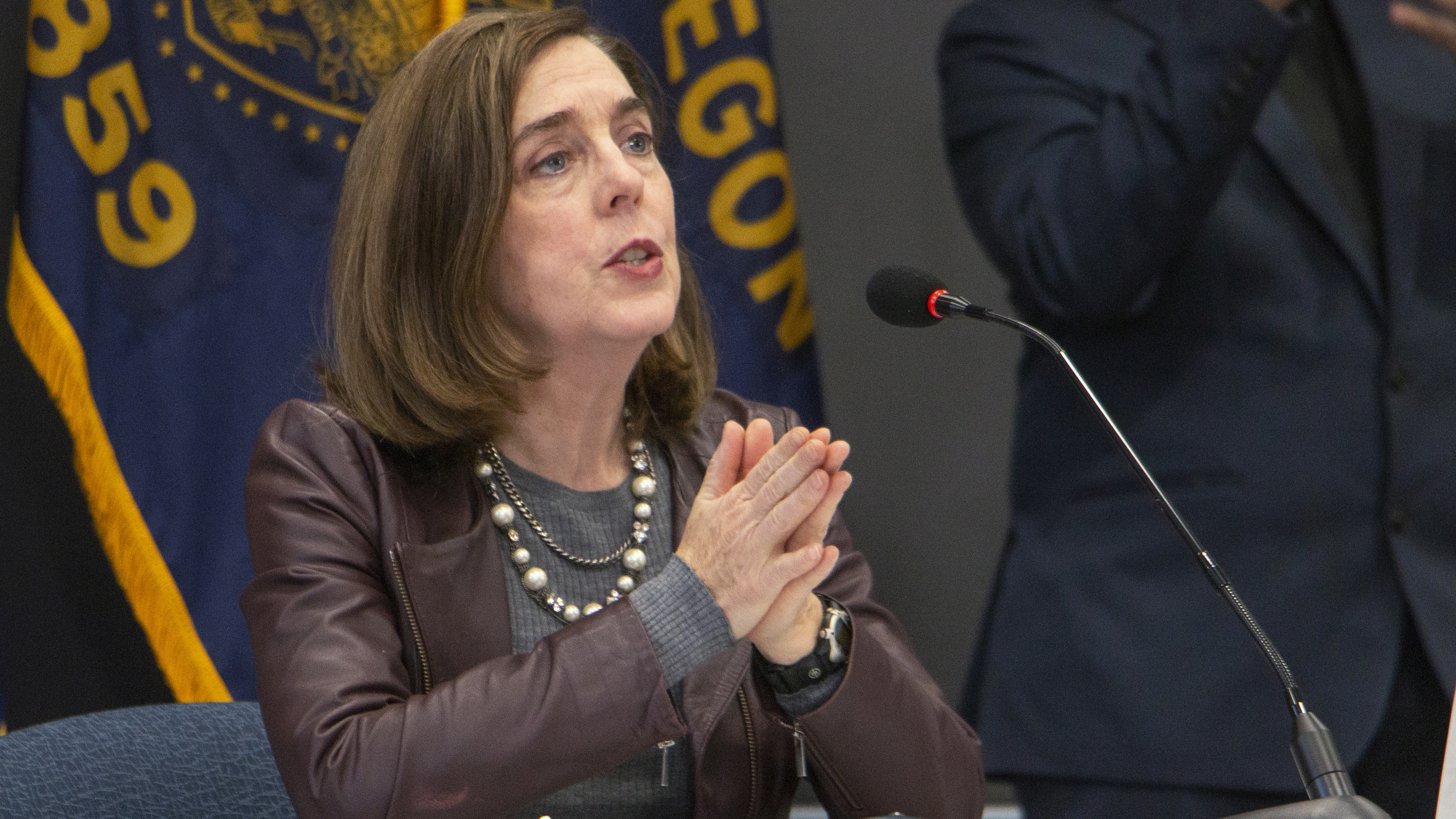 Oregon Gov. Kate Brown (shown here on Nov. 10) has ordered new statewide restrictions to head off a resurgence in coronavirus cases.