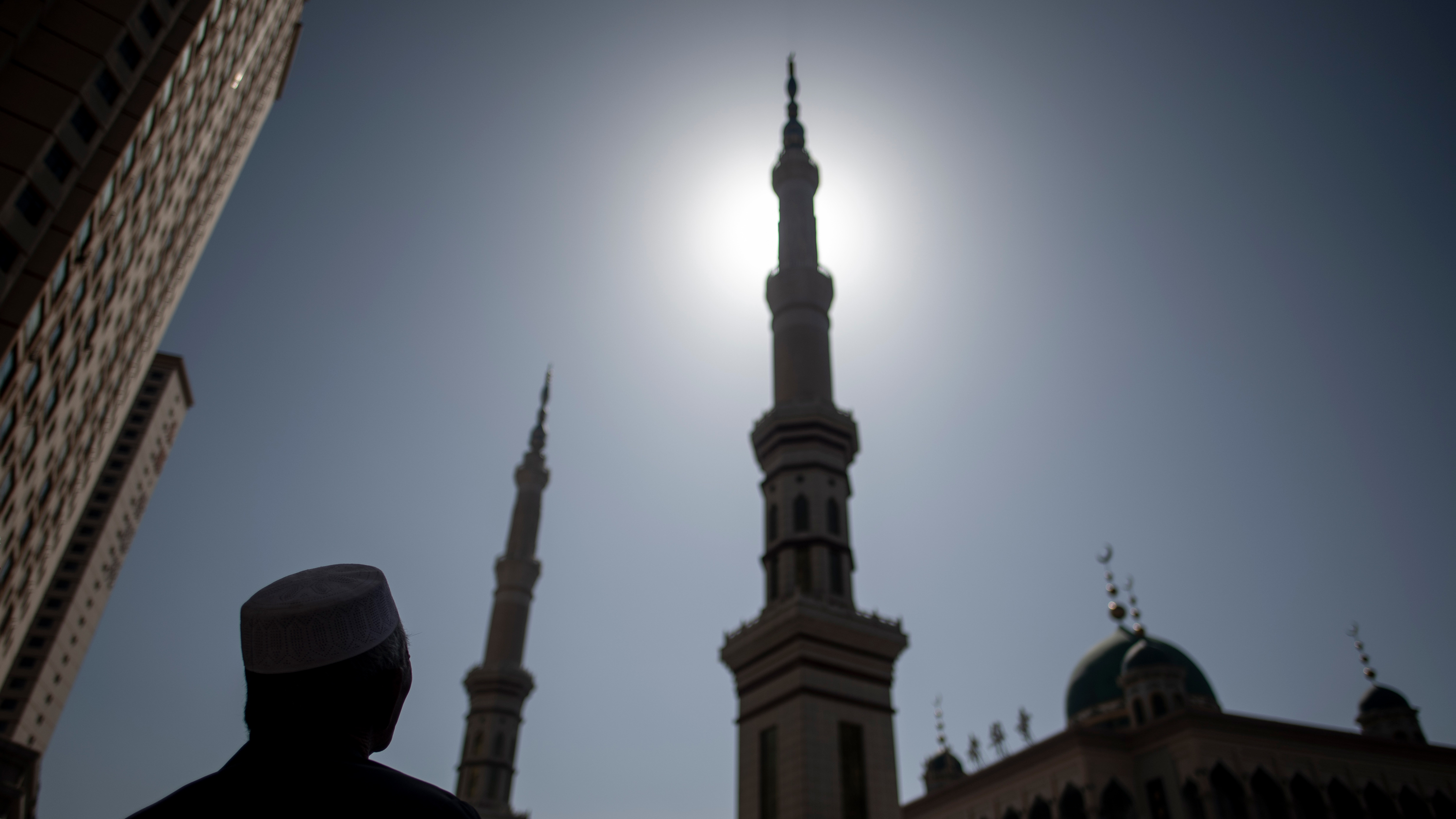 An ethnic Hui Muslim man stands in front of Laohuasi Mosque in Linxia, Gansu province, in 2018. Chinese Muslims are most densely clustered in the northwestern regions of Gansu, Ningxia and Xinjiang, but live across the country, as they have for more than a millennium.