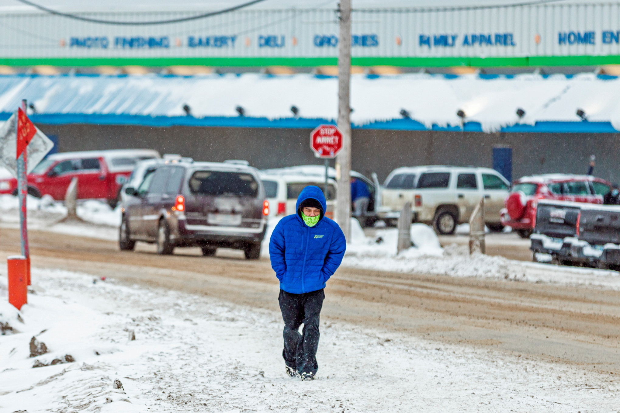 A man wears a mask as the territory of Nunavut enters a two week mandatory restriction period in Iqaluit, Nunavut, Canada, on Wednesday. More than 80 COVID-19 cases have been identified this month in Nunavut, where around 39,000 people, predominantly Inuit, live in communities scattered across the territory. (Reuters)