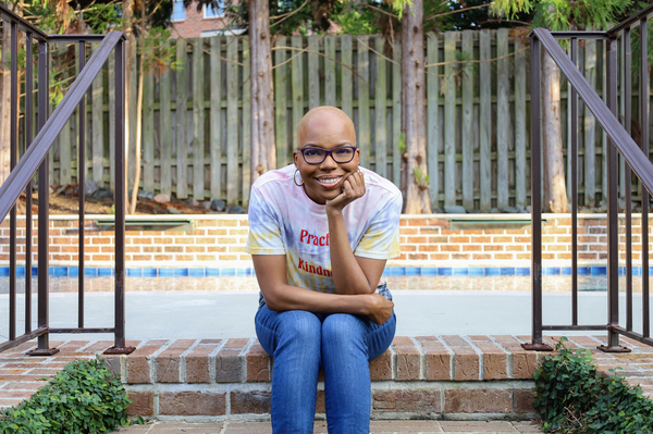 Crystal Watts sits in front of her grandmother's house in Evans, Ga.