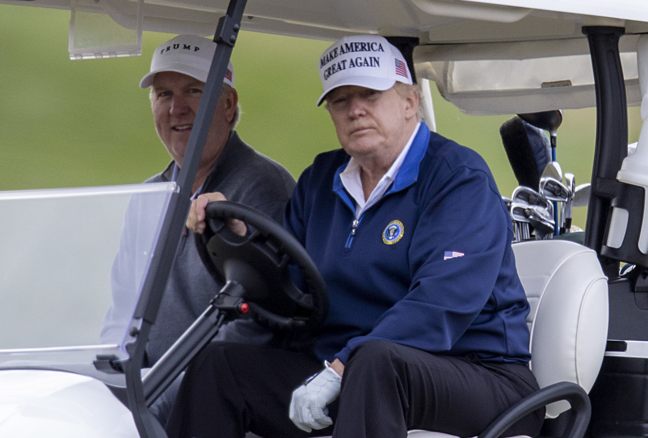 President Trump drives a golf cart Sunday at Trump National Golf Club in Sterling, Va. (Getty Images)