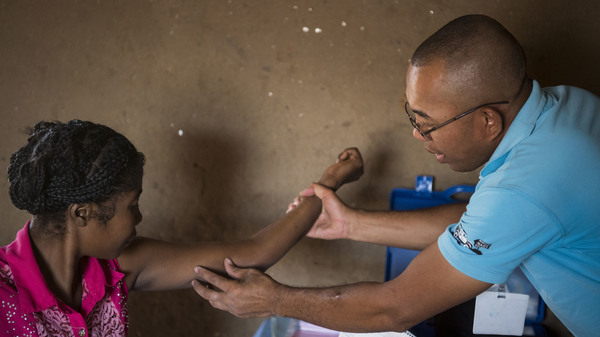 Nana (left) gets her birth control implant checked by Dr. Jean Rangomana during the Marie Stopes International mobile clinic in Besakoa, Madagascar, on April 9, 2018. Abortion is illegal under all circumstances in Madagascar, and Trump administration policies led to shortages of birth control there, health workers say.