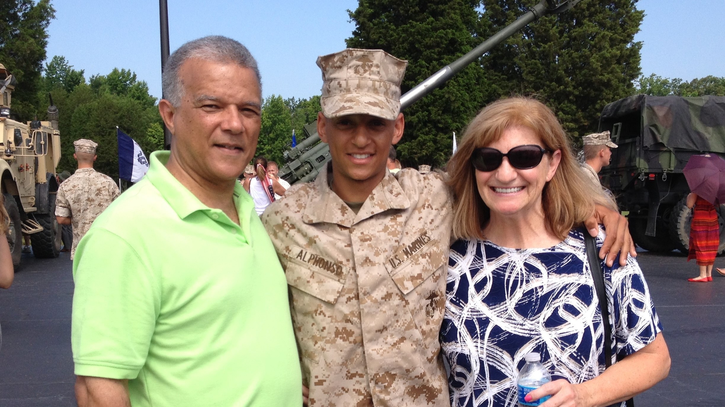 Marine Capt. Cristian Alphonso, center, pictured with his parents, Bonny, left, and Karen, right, in 2014. Alphonso was unable to visit his parents before an upcoming deployment because of Defense Dept. travel restrictions.