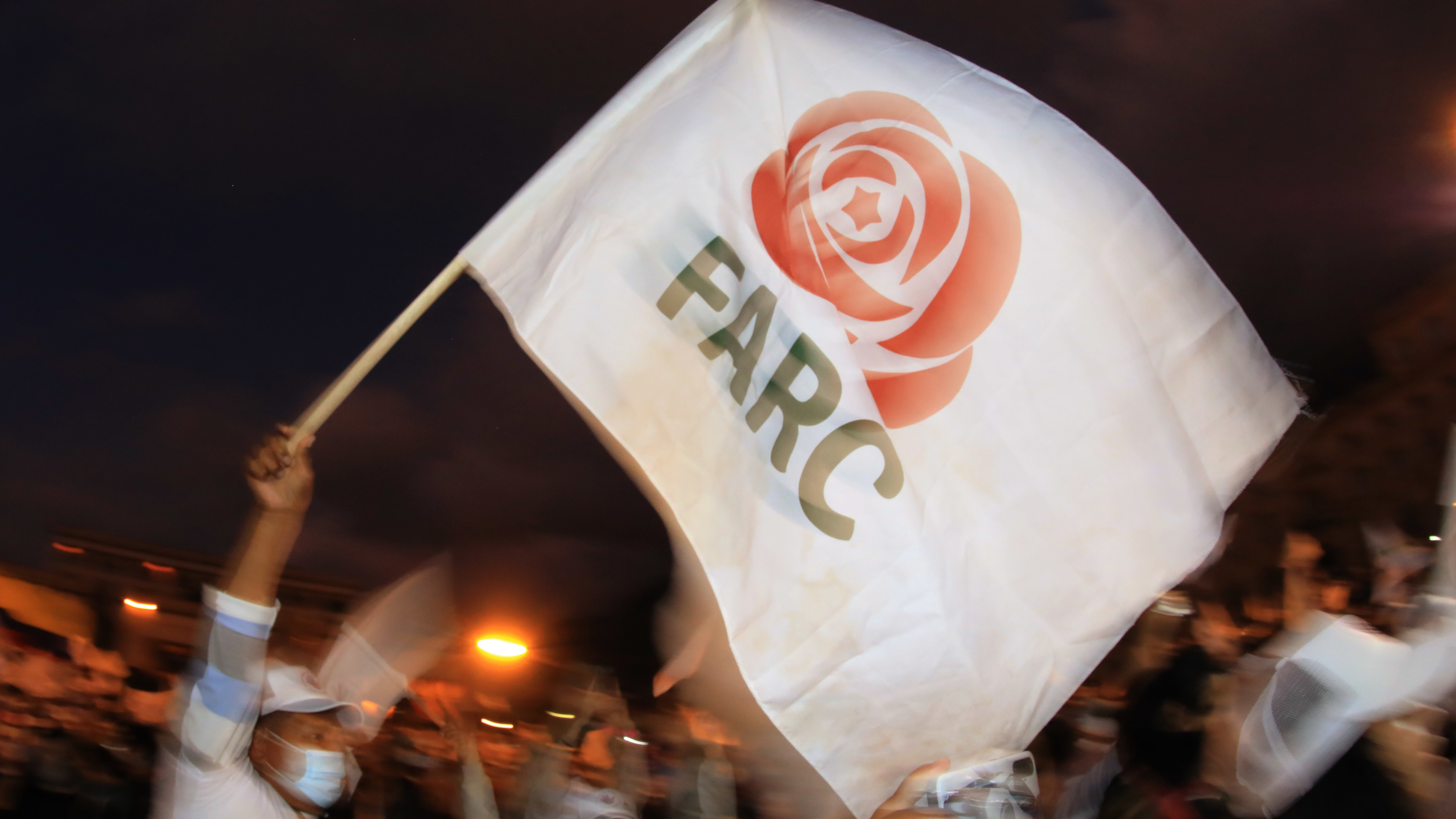 A former FARC guerrilla member waves a FARC political party flag during a demonstration in Bogota on Nov. 2. A federal court overturned an asylum decision Wednesday, holding that FARC death threats counted as persecution.×