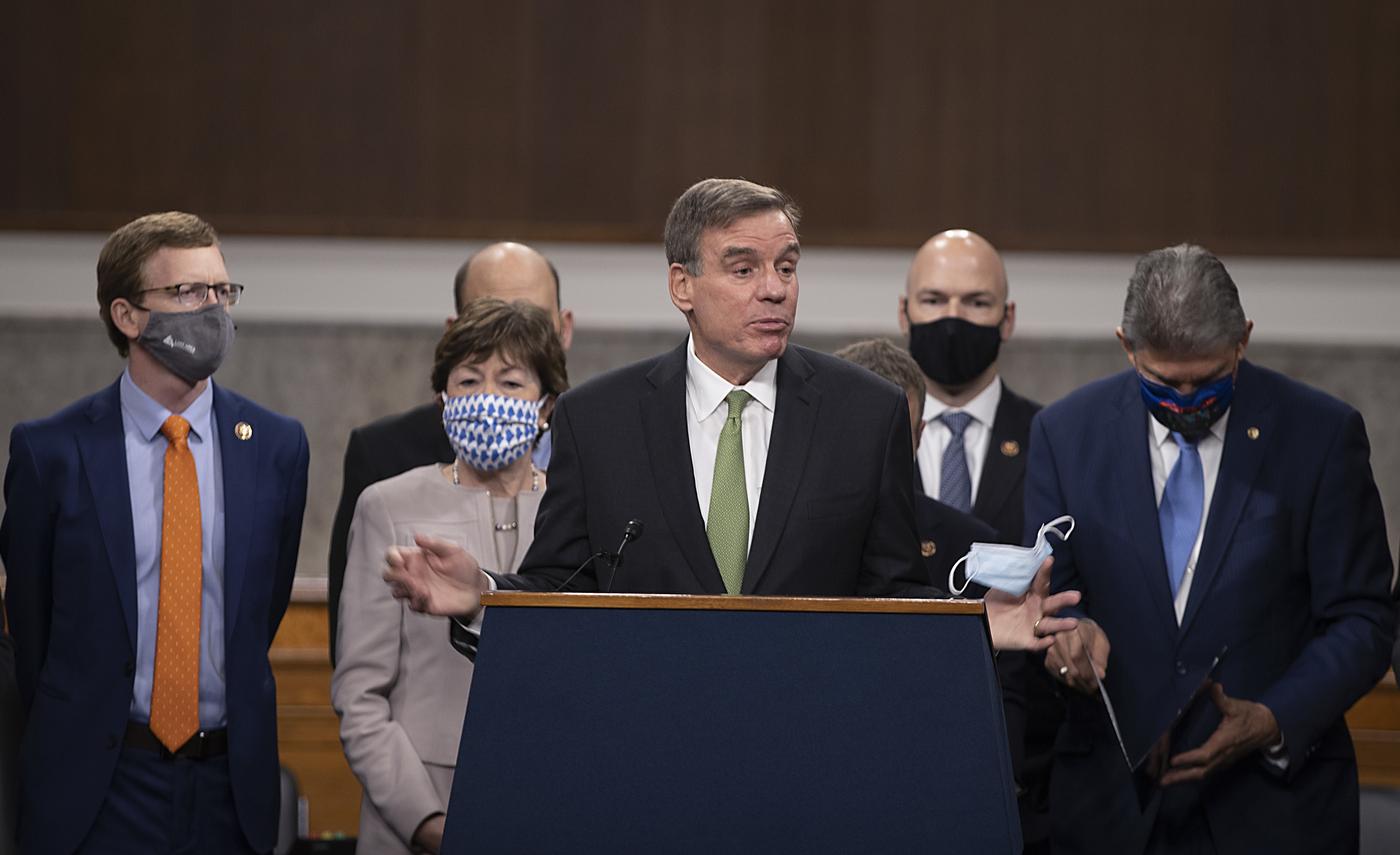 Sen. Mark Warner speaks alongside a bipartisan group of lawmakers as they announce a proposal for a $908 billion coronavirus relief bill on Tuesday. (Getty Images)