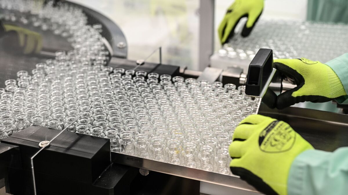 Laboratory technicians handles vials as part of filling and packaging tests for the large-scale production and supply of the University of Oxfords COVID-19 vaccine candidate, AZD1222