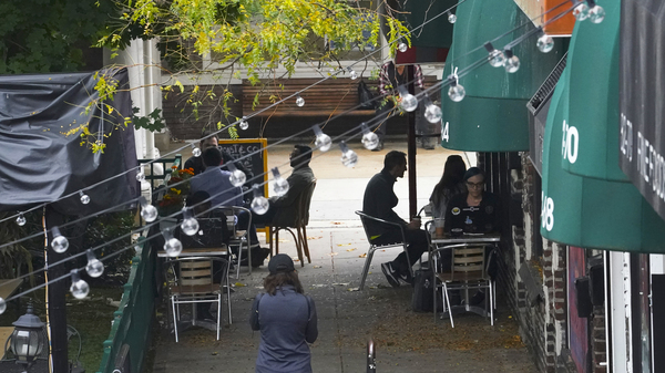 Customers sit outside a restaurant offering outdoor service in New York in October. A new survey shows that tipped service workers are facing a marked increase in harassment during the pandemic.