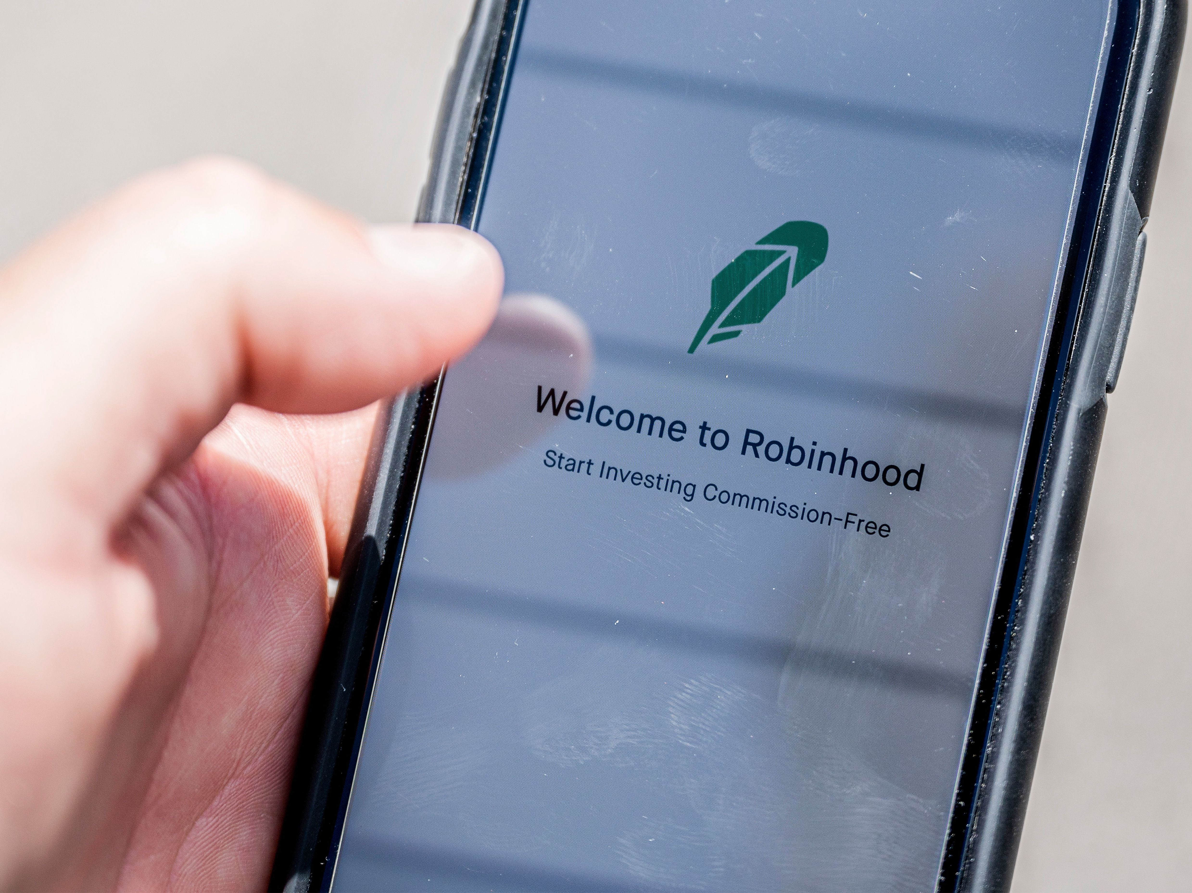 The Robinhood investment app appears on a smartphone in this photo illustration. Day trading has surged during the coronavirus pandemic as stay-at-home people try buying and selling stocks, often for the first time. (AFP via Getty Images)