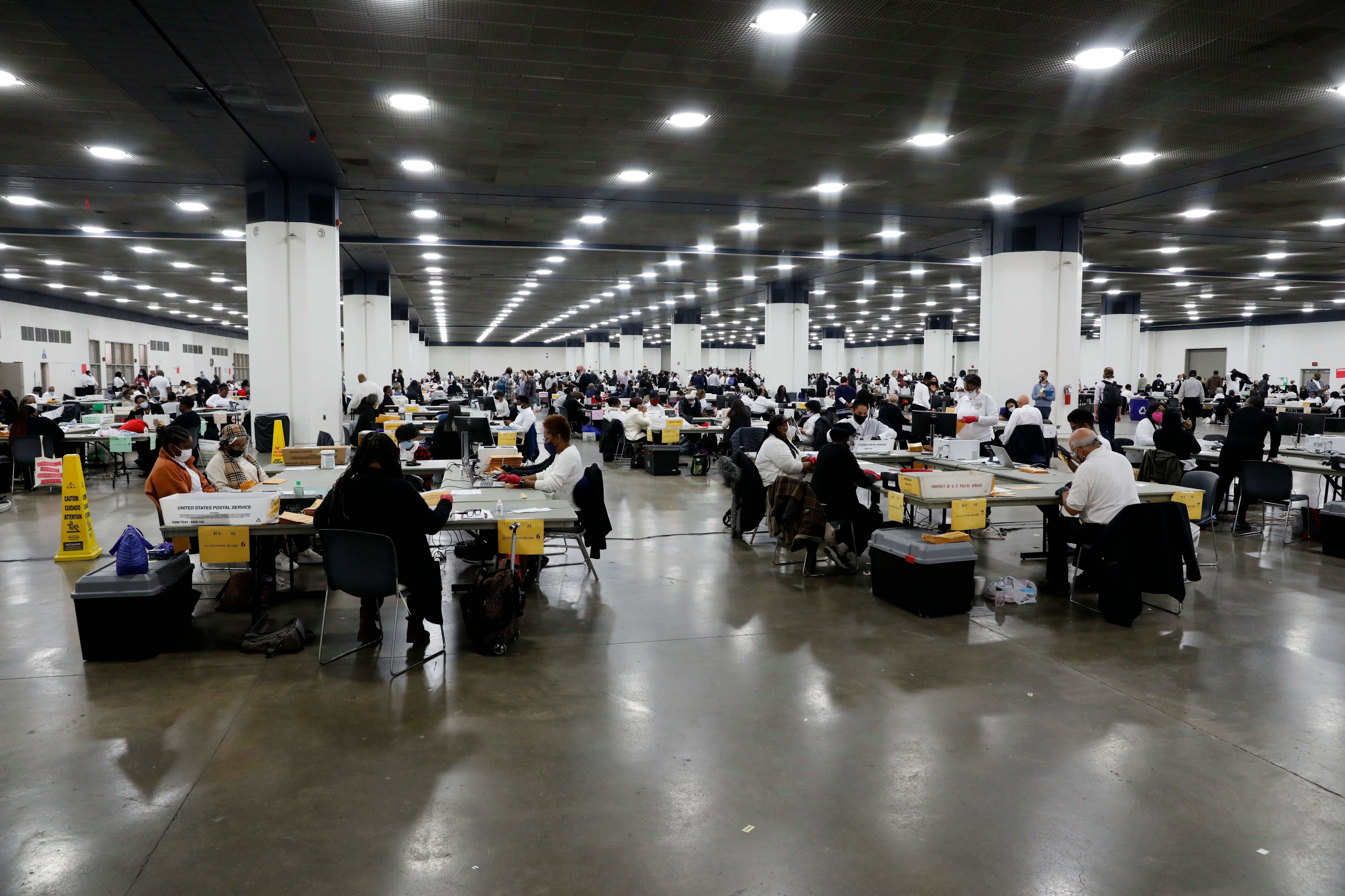 Detroit election workers count absentee ballots for the 2020 general election at TCF Center on Nov. 4. Election offices around the U.S. say they couldn't have carried out this year's challenging election without help from a nonprofit tied to Facebook CEO Mark Zuckerberg. (AFP via Getty Images)