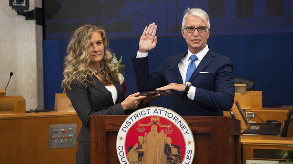 Los Angeles County District Attorney George Gascón is sworn in accompanied, by his wife Fabiola Kramsky. During his inaugural speech, he unveiled a series of criminal justice reforms that impact how prosecutors in his office pursue convictions, sentencing and cash bail.