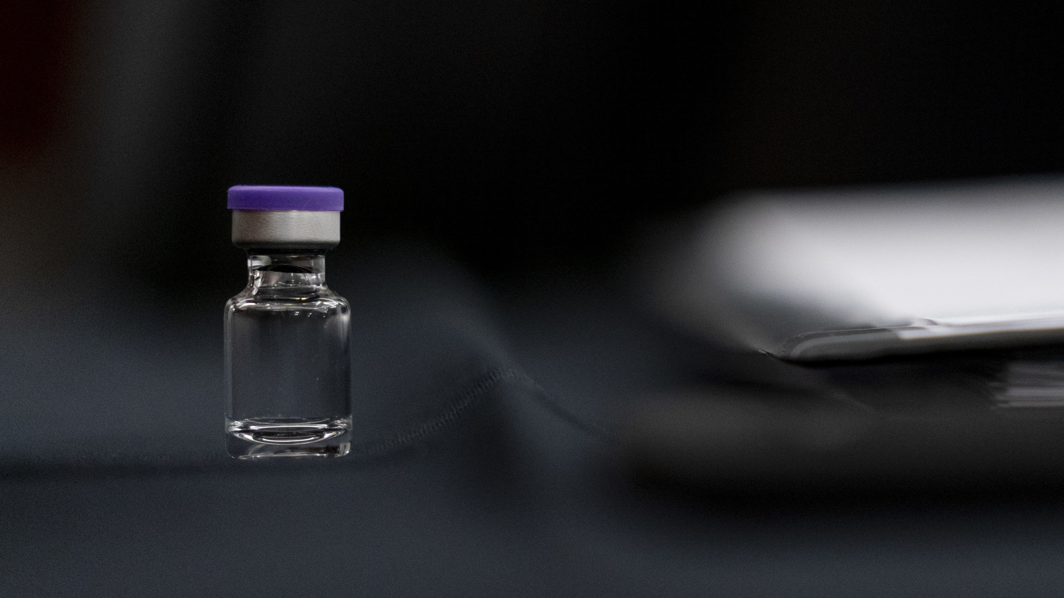 An example of a vial that will carry the COVID-19 vaccine produced by Pfizer and BioNTech sits on display during a Senate subcommittee hearing Thursday. (Pool/Getty Images)
