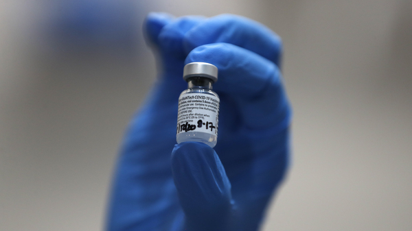 A nurse holds a vial of the COVID-19 vaccine produced by Pfizer and BioNTech, in London earlier this week. Food and Drug Administration officials in the U.S. sought to reassure the public about the vaccine Saturday after authorizing it for emergency use.