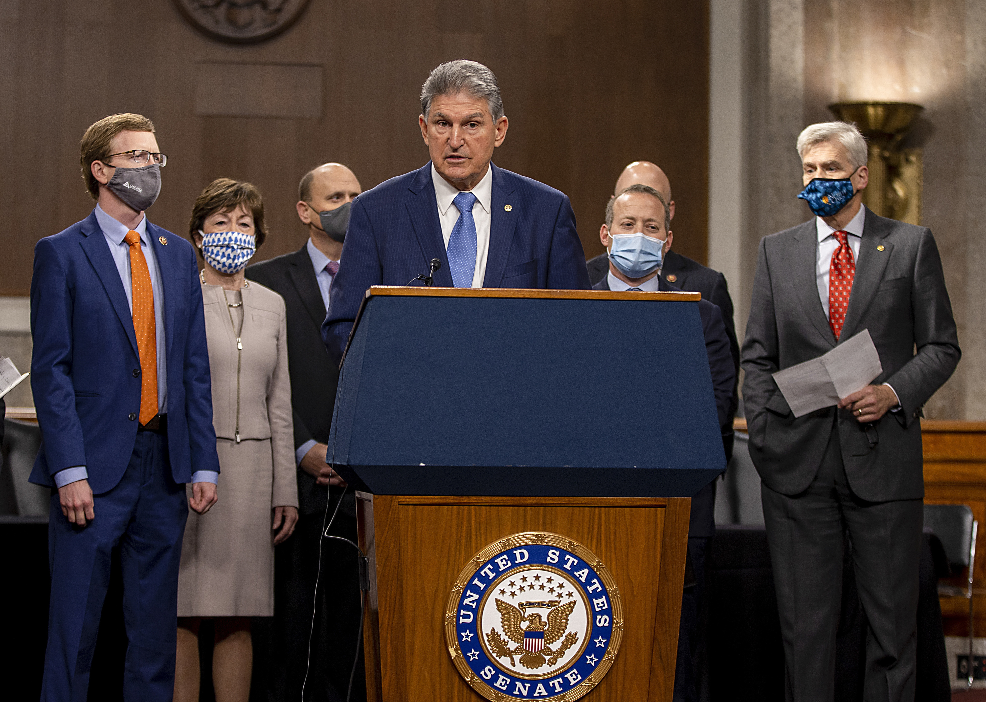 West Virginia Sen. Joe Manchin, who's seen here alongside a group of Democratic and Republican members of Congress as they announce a proposal for a COVID-19 relief bill on Dec. 1, said Sunday that negotiations on the bill's text are ongoing. (Getty Images)