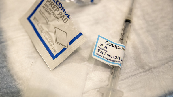 An empty syringe on a table at Ronald Reagan UCLA Medical Center after a care worker received the COVID-19 vaccine on Dec. 16, 2020.