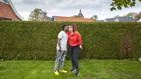 Patrick Phiri of Malawi and fiance Fiona ten Have of Holland kiss in her parents