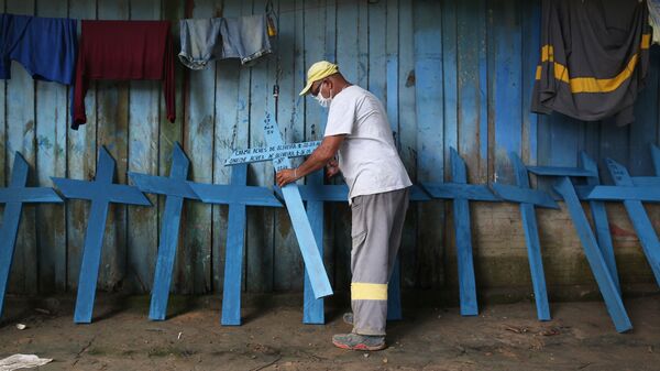 Ulisses Xavier, 52, who has worked for 16 years at Nossa Senhora cemetery in Manaus, Brazil, makes wooden crosses to supplement his income. The cemetery has seen a surge in the number of new graves after the outbreak of COVID-19.