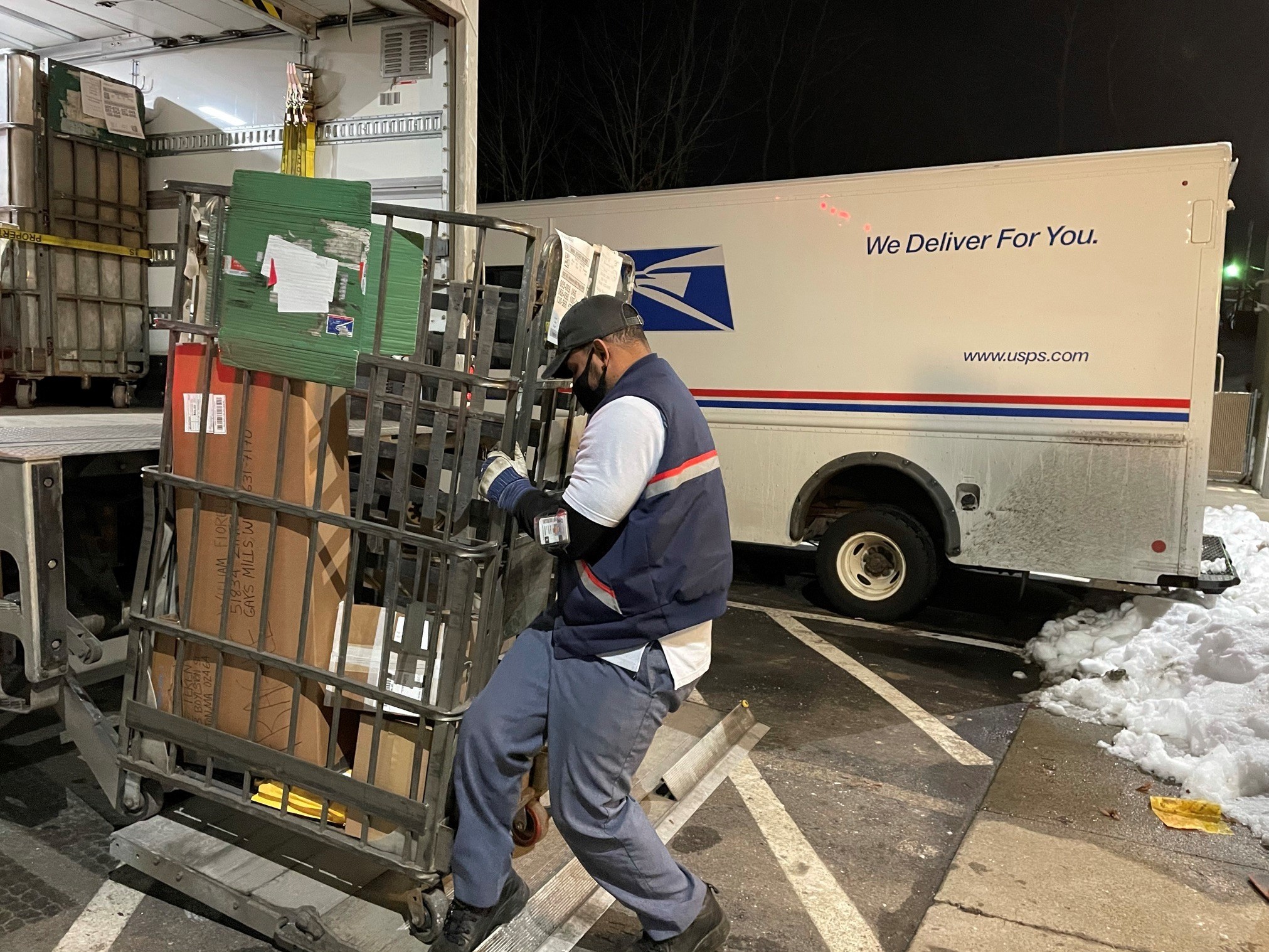Like many of his colleagues, postal worker Rickey Ramirez is working overtime to keep up with the crush of Christmas deliveries. Many packages are likely to be delivered after Dec. 25. (NPR)