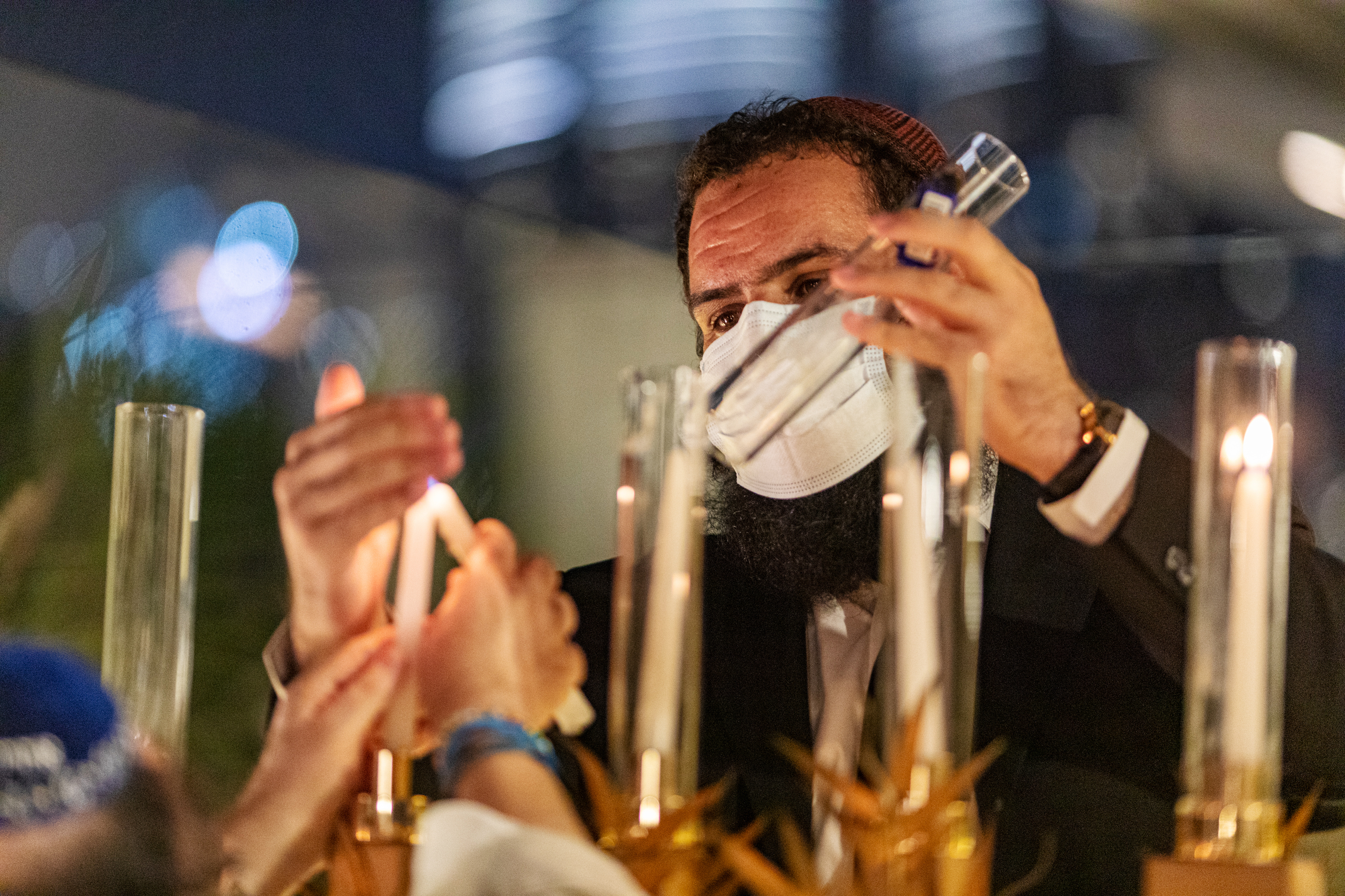 Rabbi Levi Duchman lights a menorah during Hanukkah at a private residence in Dubai, United Arab Emirates, in December. (Christopher Pike for NPR)