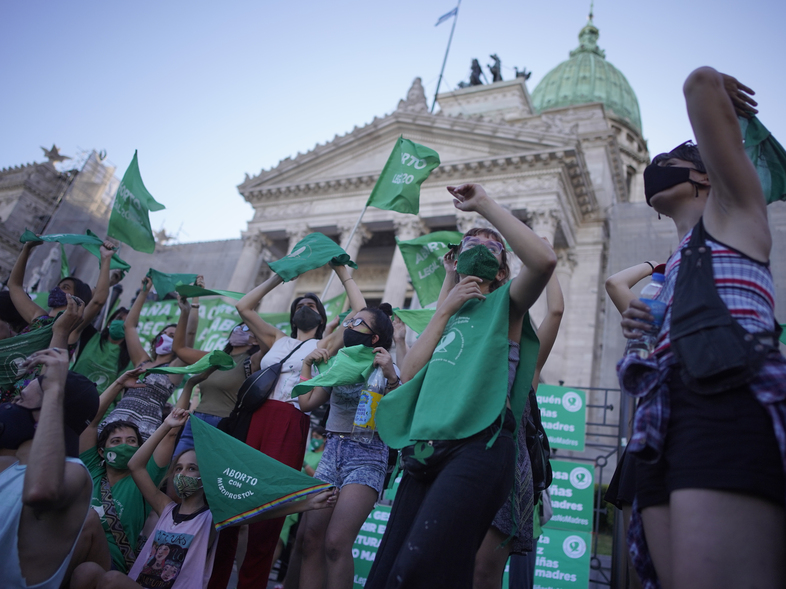 Abortion-rights activists in favor of a bill legalizing abortion gather outside the legislative building in Buenos Aires on Thursday. (Victor R. Caivano/AP)