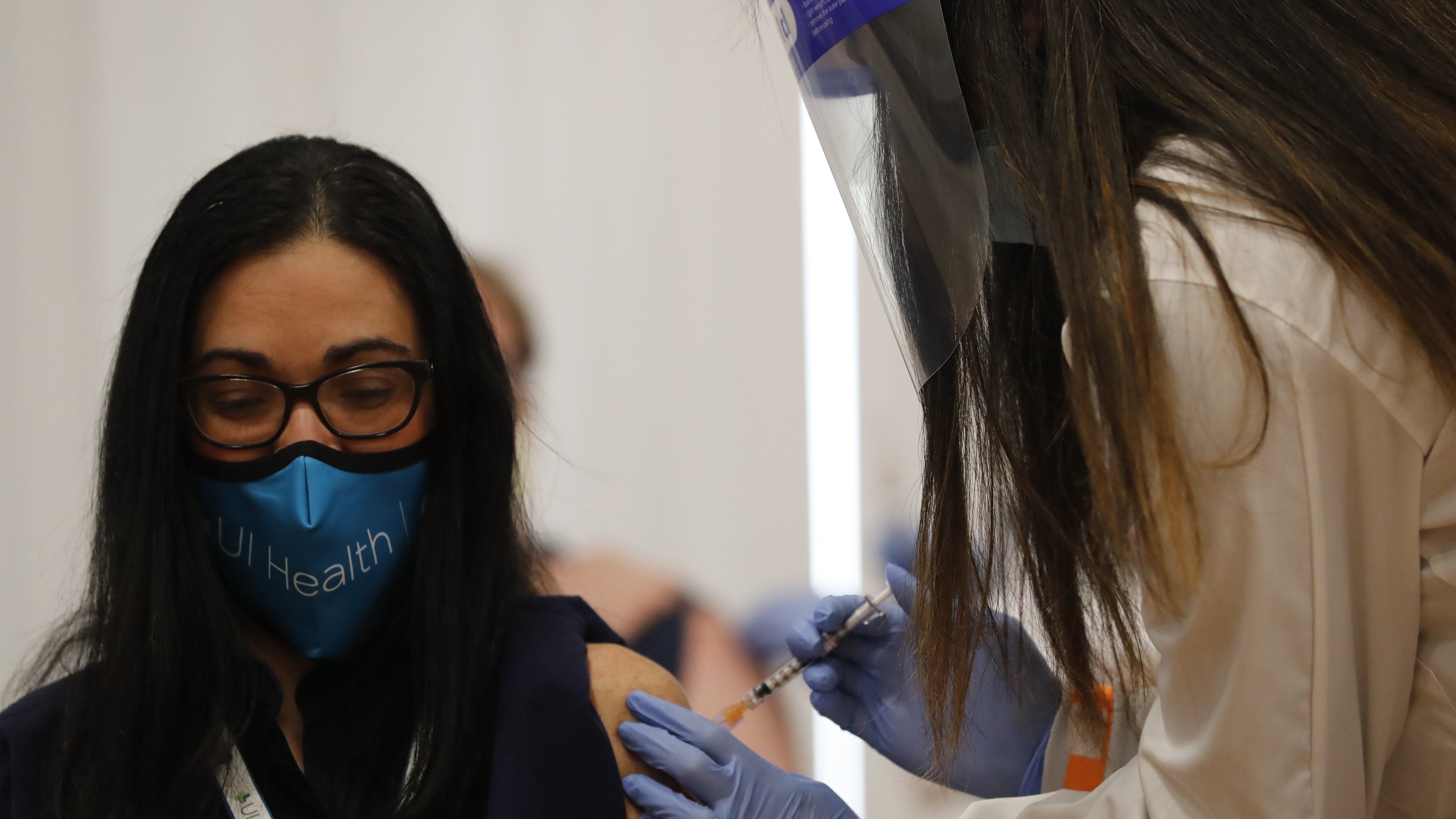 Dr. Nikhila Juvvadi gives Dr. Marina Del Rios from the University of Illinois Hospital & Health Sciences System one of the first COVID-19 vaccination administered in Chicago on Dec. 15 at Loretto Hospital on the city