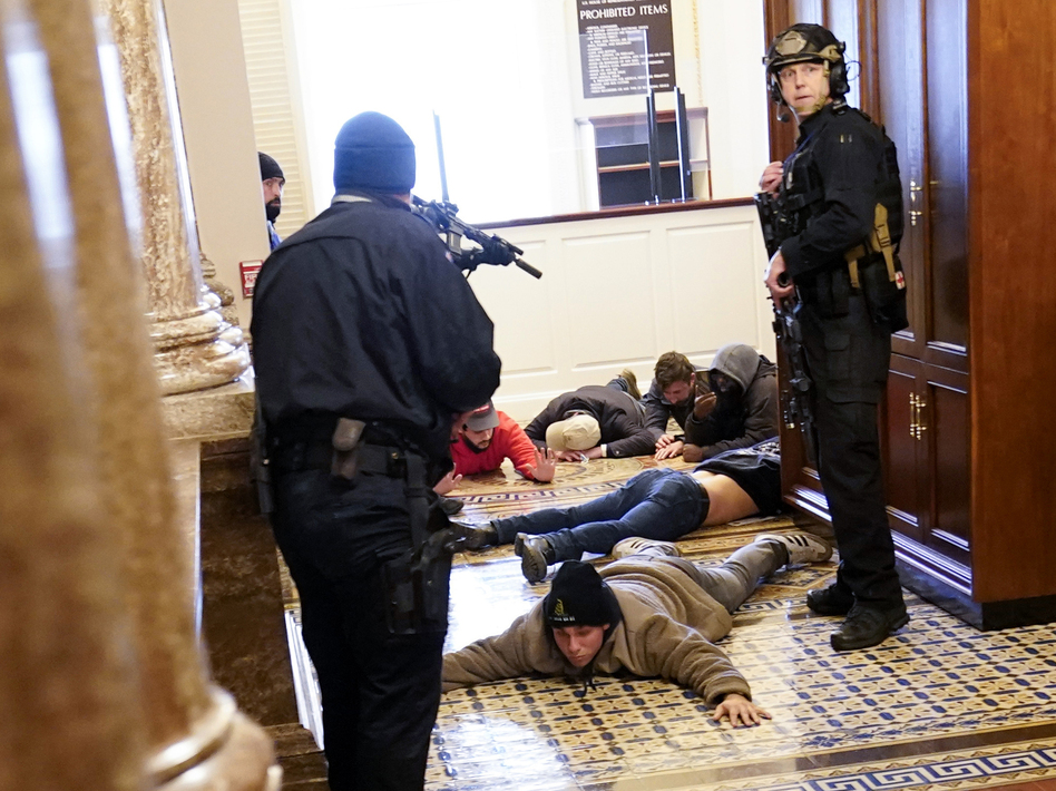 U.S. Capitol Police hold protesters at gunpoint near the House Chamber inside the U.S. Capitol on Wednesday. (Andrew Harnik/AP)