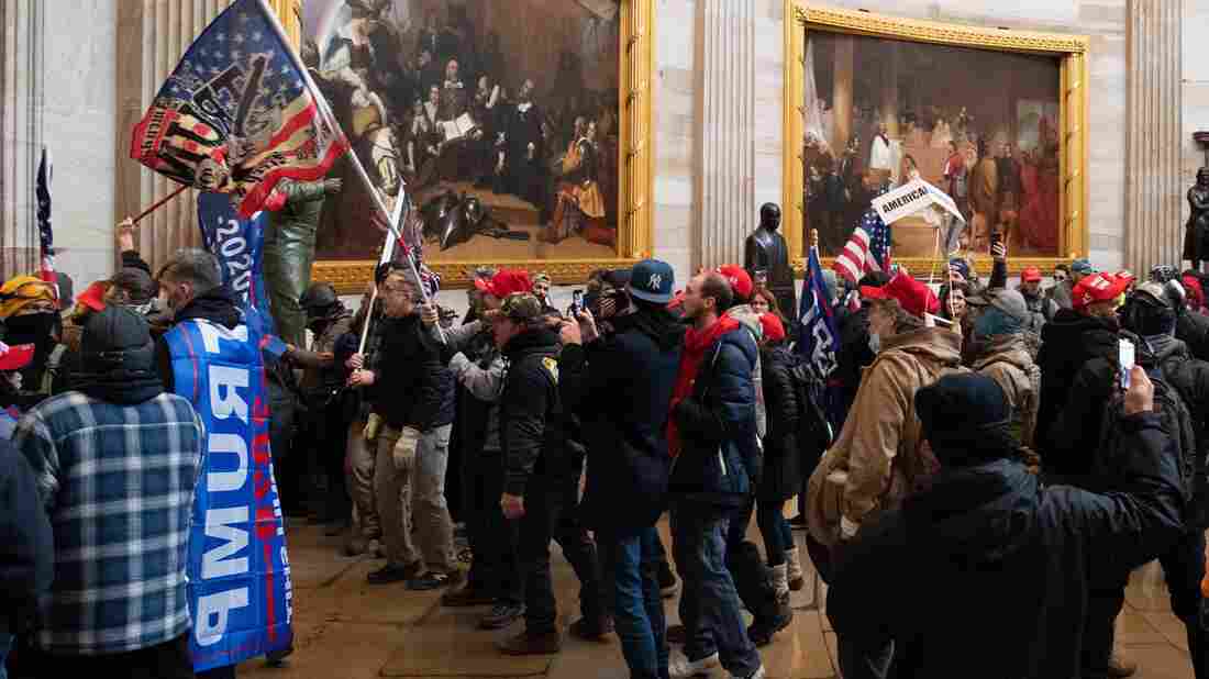Supporters of US President Donald Trump protest in the US Capitol Rotunda on January 6, 2021, in Washington, DC. - Demonstrators breeched security and entered the Capitol as Congress debated the a 2020 presidential election Electoral Vote Certification. (Photo by SAUL LOEB / AFP) (Photo by SAUL LOEB/AFP via Getty Images)