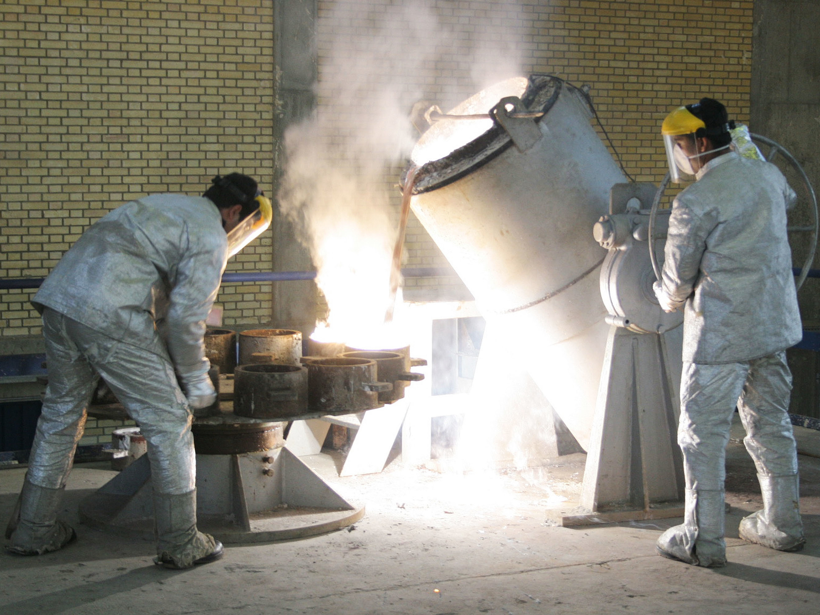 Technicians work inside of a uranium conversion facility producing unit in 2005 outside the city of Isfahan, Iran. After the 2015 Iran nuclear deal put limits on the program, Iran's government has been increasing uranium enrichment since the United States pulled out of deal. (Getty Images)