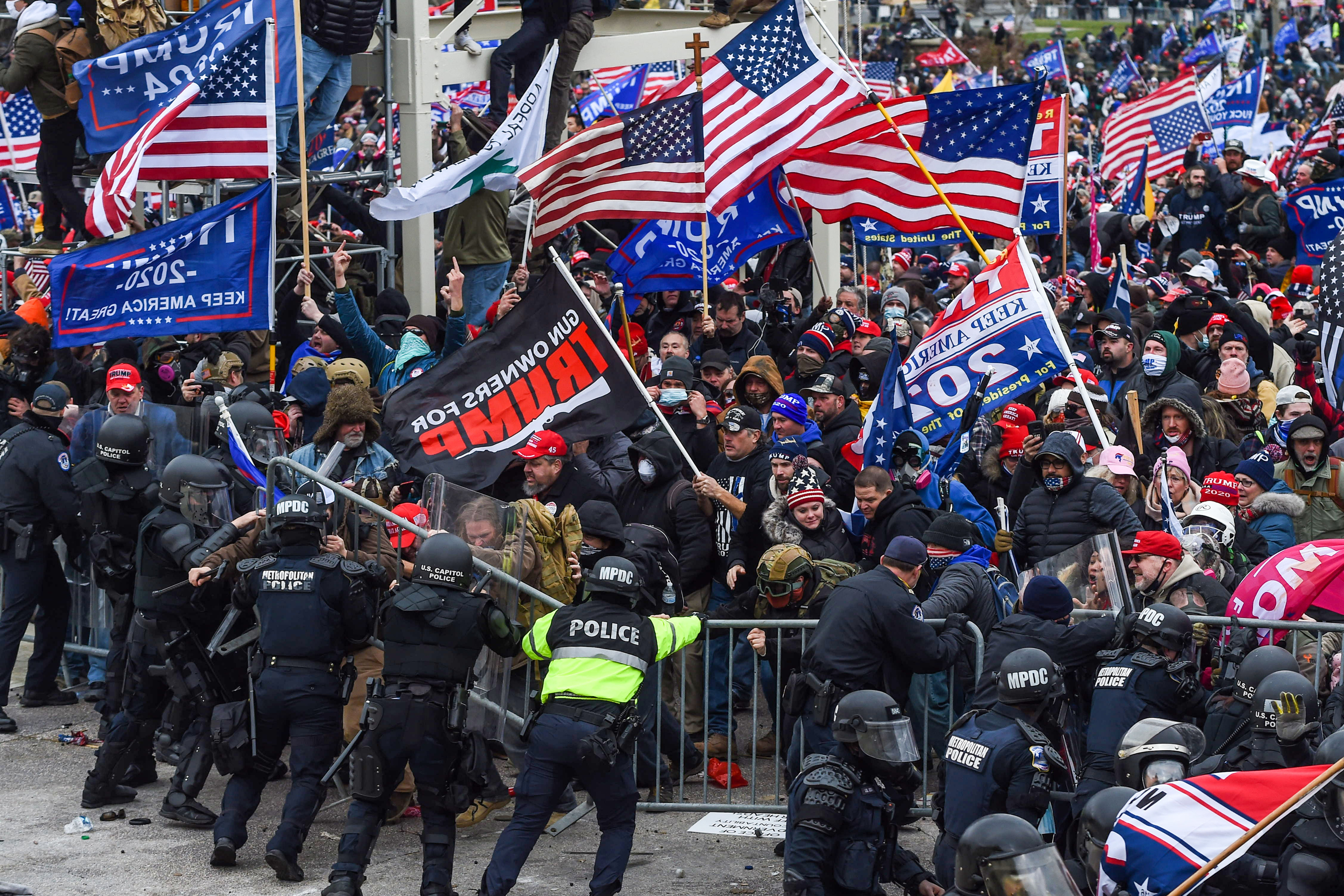 Police and security forces attempt to hold back a mob of pro-Trump extremists as they storm the U.S. Capitol in Washington on Wednesday. (AFP via Getty Images)