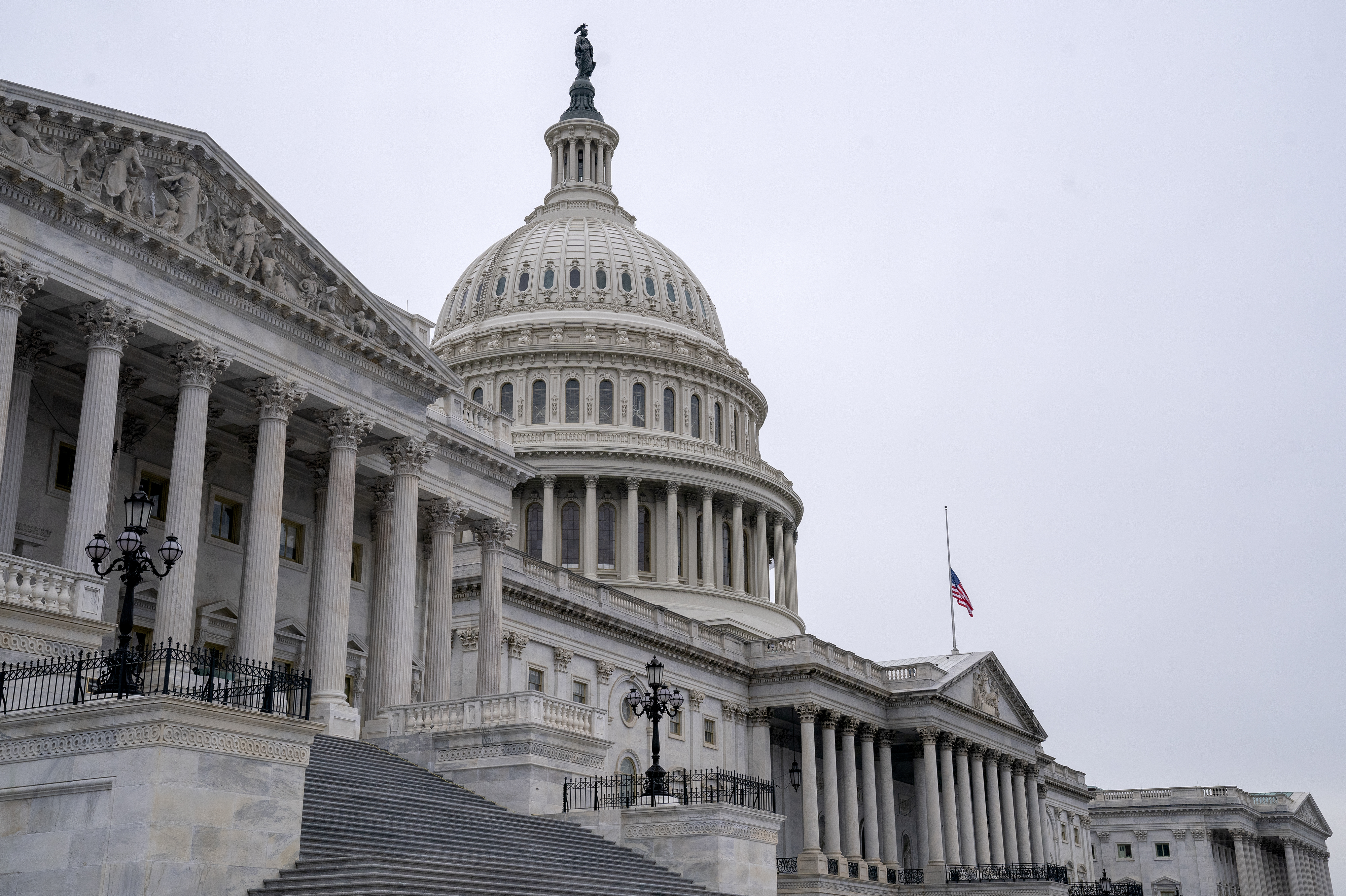 An American flag flies at half staff at the U.S. Capitol on Monday to honor two U.S. Capitol Police officers who died following the violence on Capitol Hill. (Getty Images)