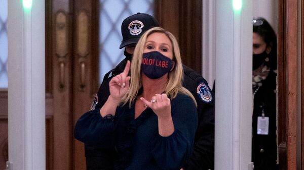 Republican Rep. Marjorie Taylor Greene of Georgia shouts at journalists as she goes through security outside the House Chamber at Capitol Hill.
