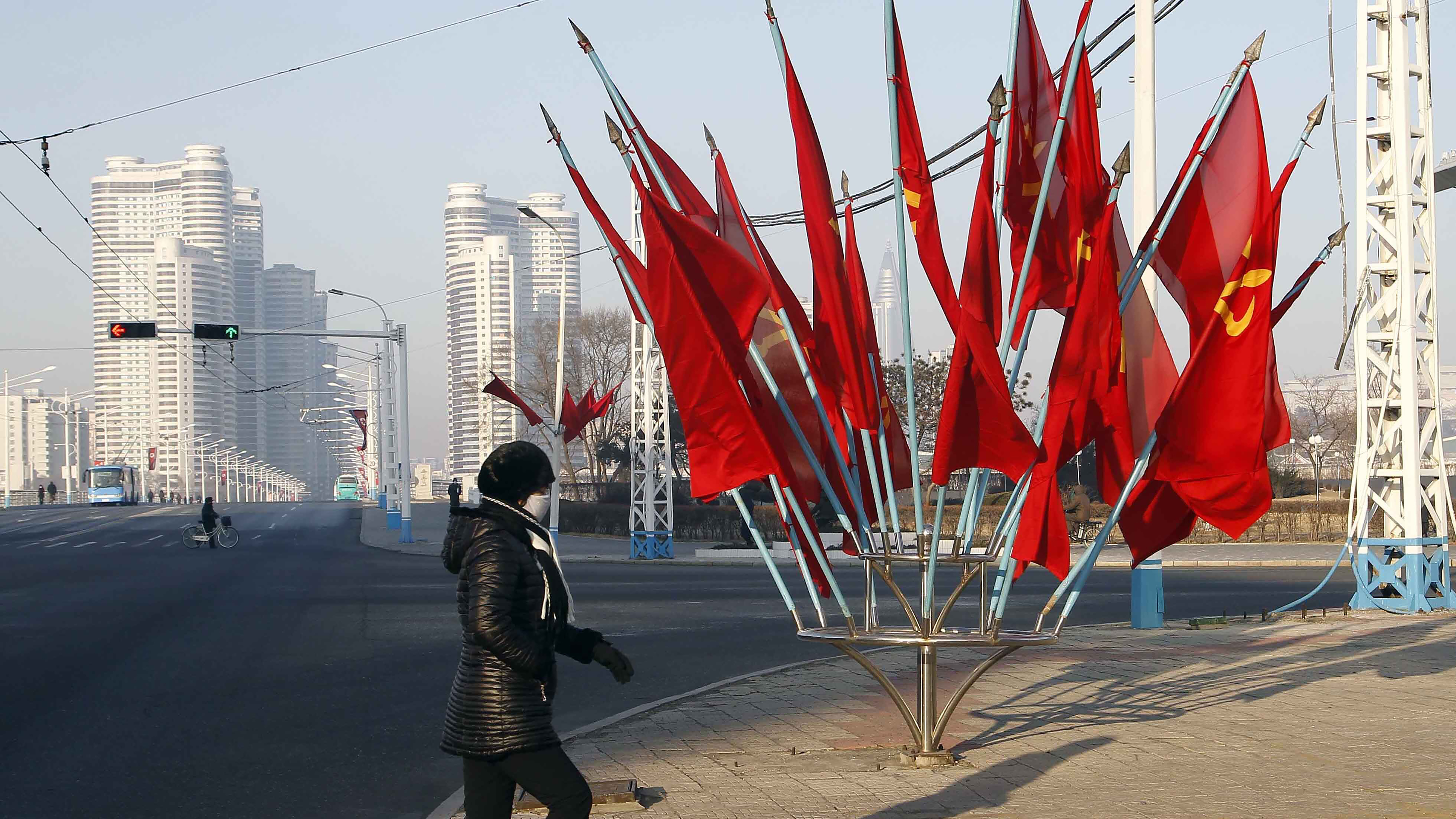 A person passes by a bouquet of Workers Party flags along a main street of the Central District in Pyongyang, North Korea, last week.