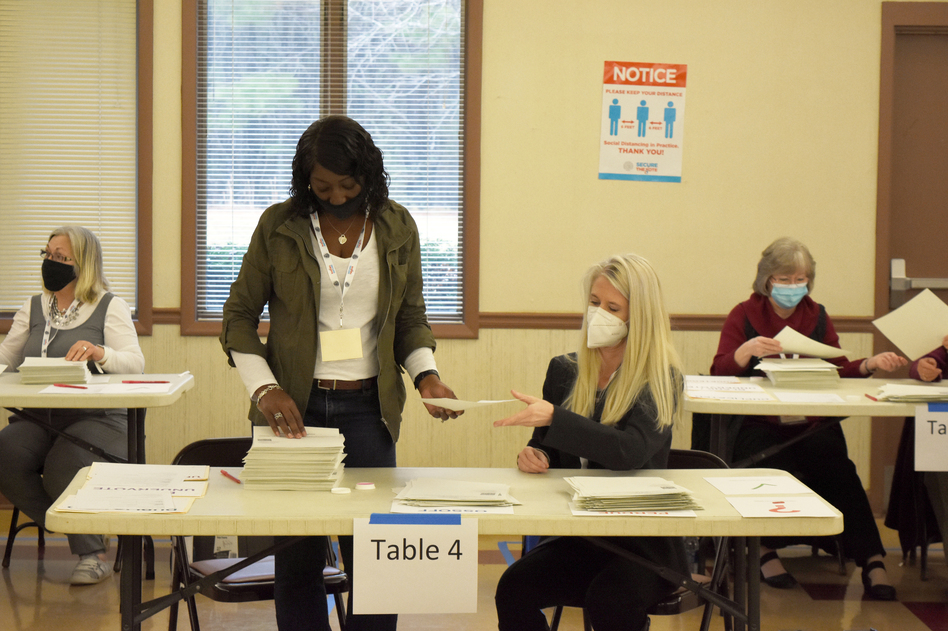 Bartow County, Ga. election workers conduct a full hand count of ballots in the Jan. 5 Senate runoff between former Sen. David Perdue and Sen.-elect Jon Ossoff as part of a voluntary recount aimed at improving voter confidence.