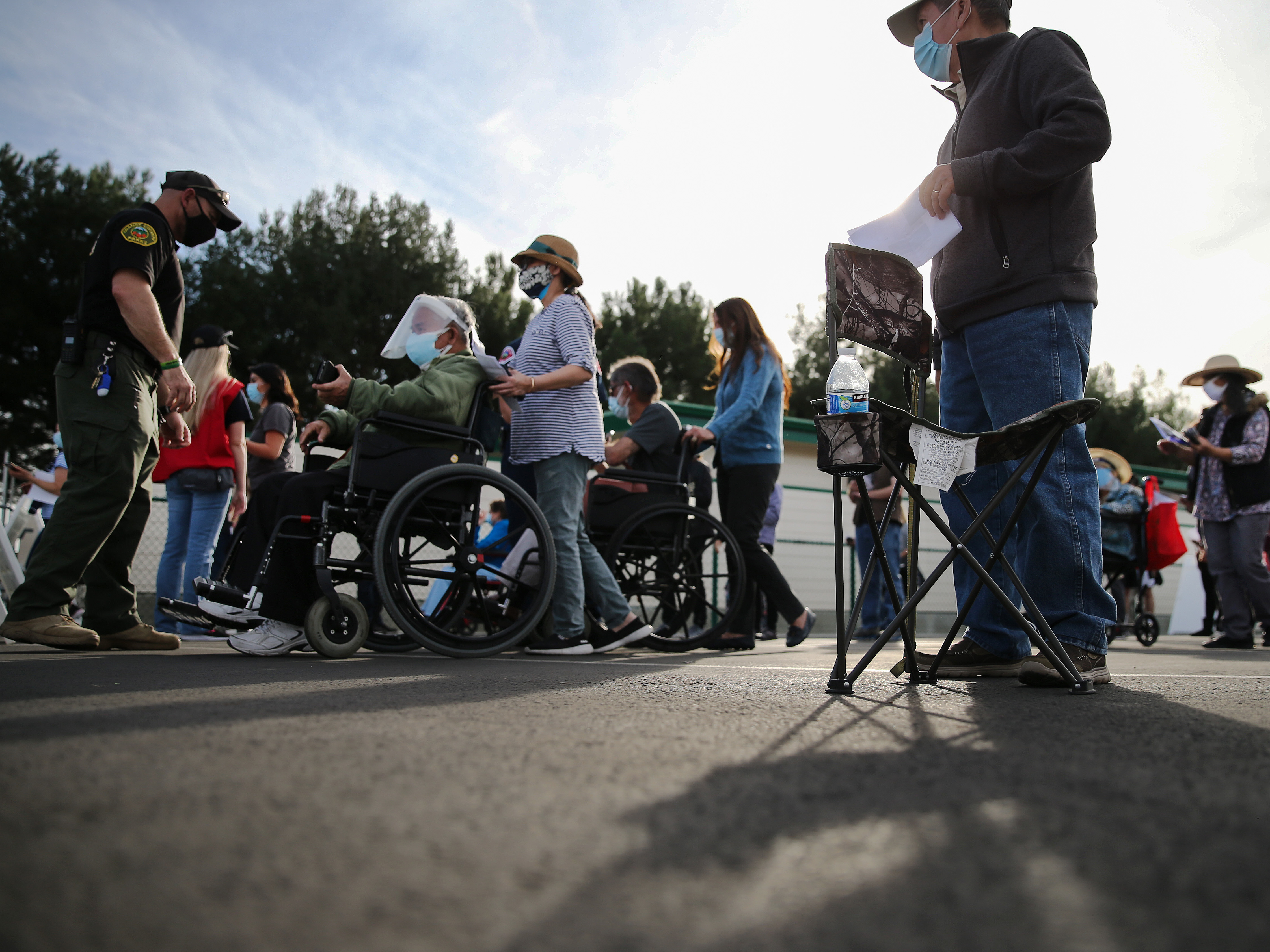 People lined up to receive the COVID-19 vaccine at a mass vaccination site in Disneyland's parking lot in Anaheim, Calif. on Jan. 13. The state says all residents 65 or older are now eligible to receive the vaccine. (Getty Images)