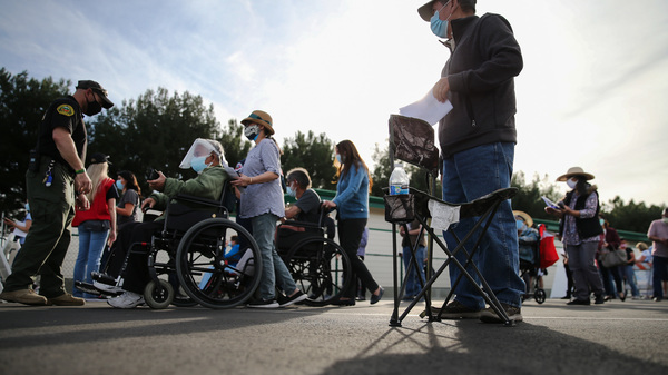 People lined up to receive the COVID-19 vaccine at a mass vaccination site in Disneyland