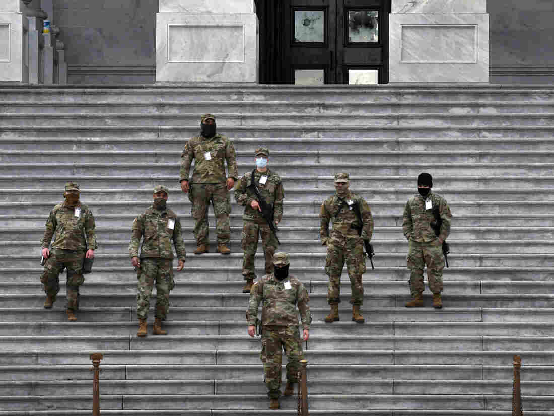 National Guard troops provide security at the U.S. Capitol for the upcoming inauguration for President-elect Joe Biden amid threats by extremist supporters of Donald Trump in Washington DC on January 17, 2021. There were threats to storm capitols in all 50 states but the day remained quiet. Shattered windows behind them.