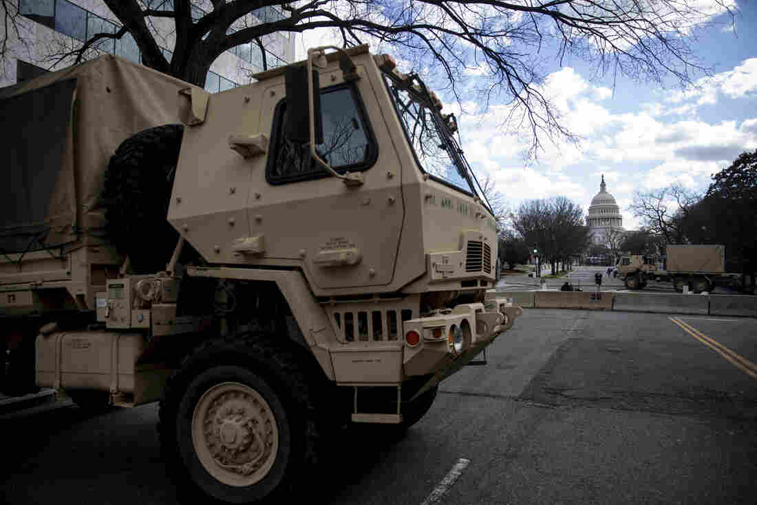 Military vehicles and concrete dividers block streets as part of the security perimeter near the U.S. Capitol.