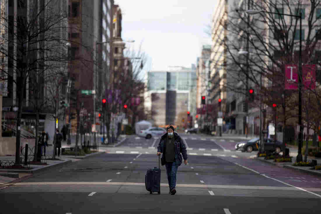 Views in downtown Washington, D.C. as Inauguration prep continues. A man walks down and empty I Street NW.