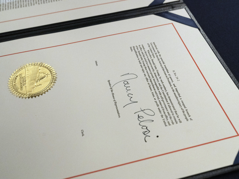 House Speaker Nancy Pelosi's signature is seen on the single article of impeachment against President Trump. The case against the president now moves to the U.S. Senate, which will consider the article after Trump is no longer in office. (Alex Brandon/AP)