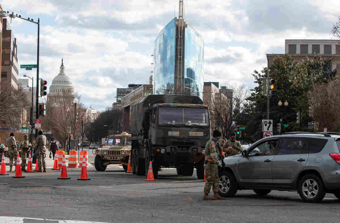 A member of the National Guard protects the perimeter fencing around the Capitol Hill.