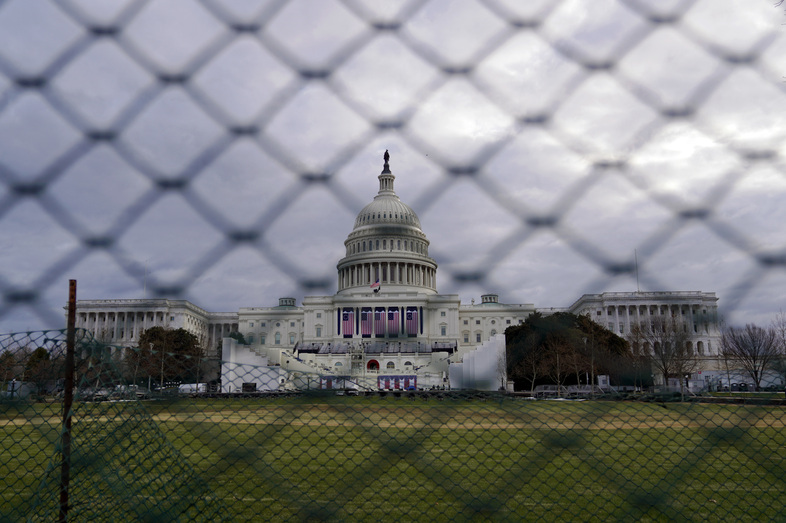 The U.S. Capitol is visible behind fences on Sunday following the Jan. 6 riot by pro-Trump extremists. This week's events will have the largest security presence of any inauguration in U.S. history. (Eric Thayer/Getty Images)
