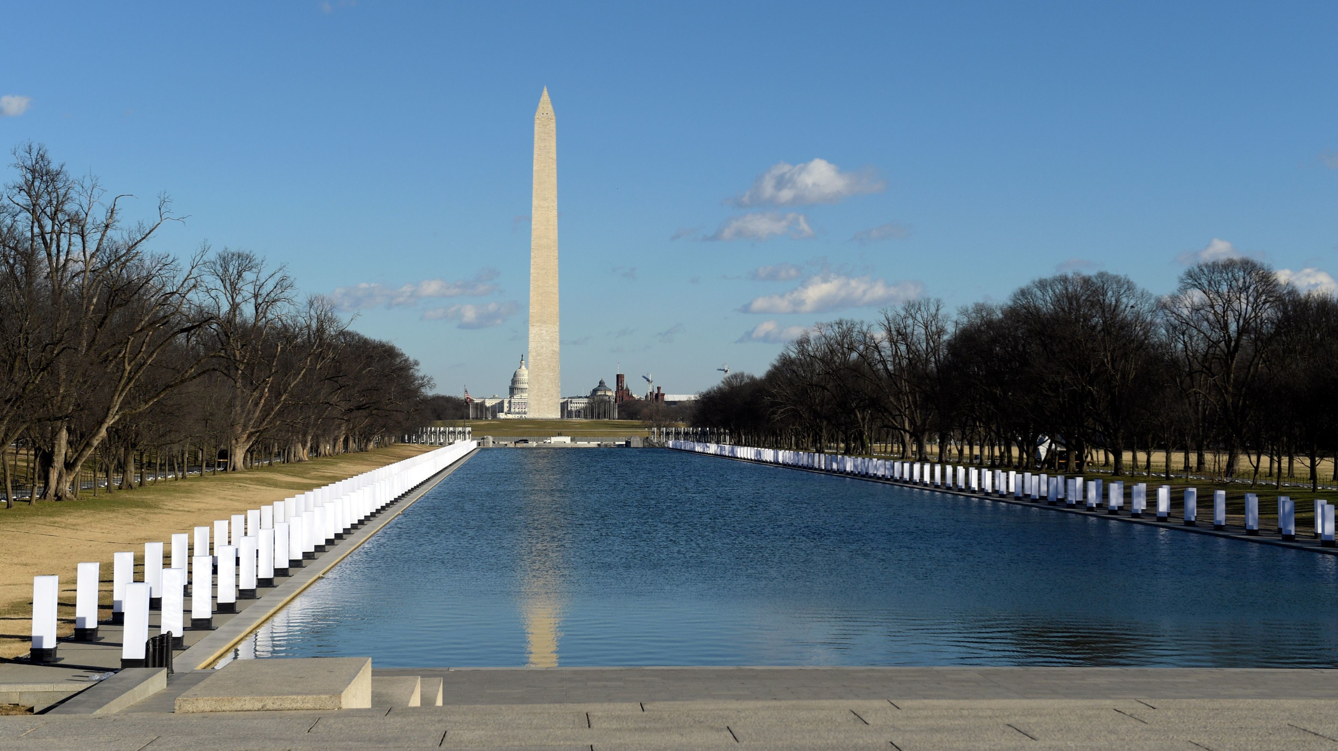 A memorial to victims of COVID-19 is seen at the Lincoln Memorial reflecting pool on Tuesday. Four hundred lights will illuminate to represent 400,000 people who have died.