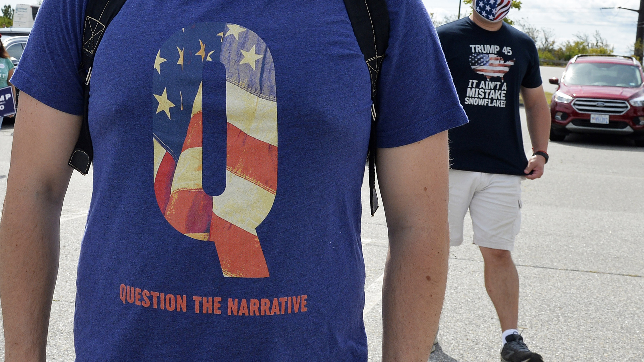 A man wears a QAnon shirt while boarding a shuttle bus in Londonderry, N.H., on Aug. 28, 2020. (AFP via Getty Images)