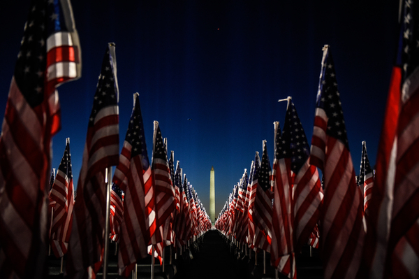 The Washington Monument is surrounded by American flags on the National Mall.