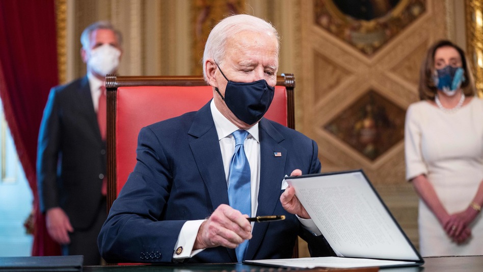 President Biden signs documents in the Presidents Room at the U.S. Capitol after taking the oath of office. (Jim Lo Scalzo/Pool/AFP via Getty Images)